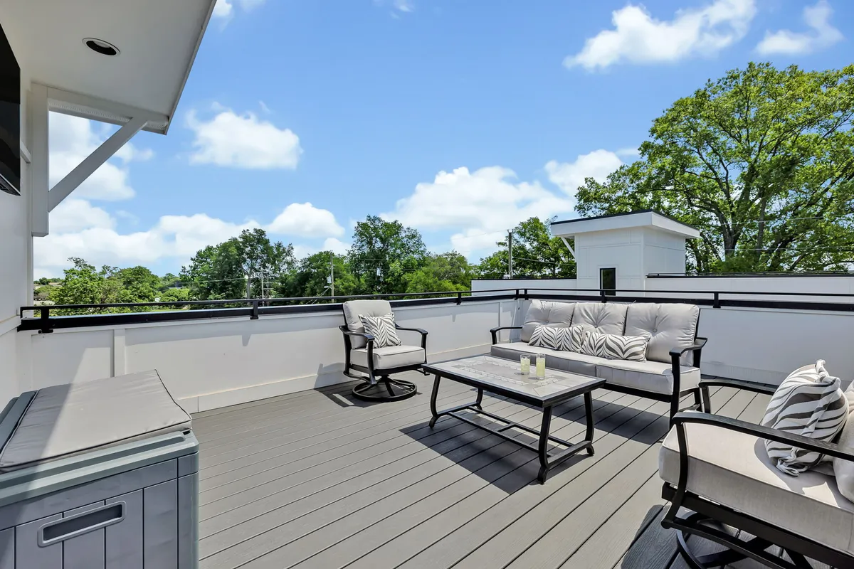 An inviting outdoor space with comfortable furniture, a candle-lit table, and sweeping landscape views. The tranquil setting suggests a perfect spot for unwinding with friends, enjoying takeout, or sipping drinks at sunset.
