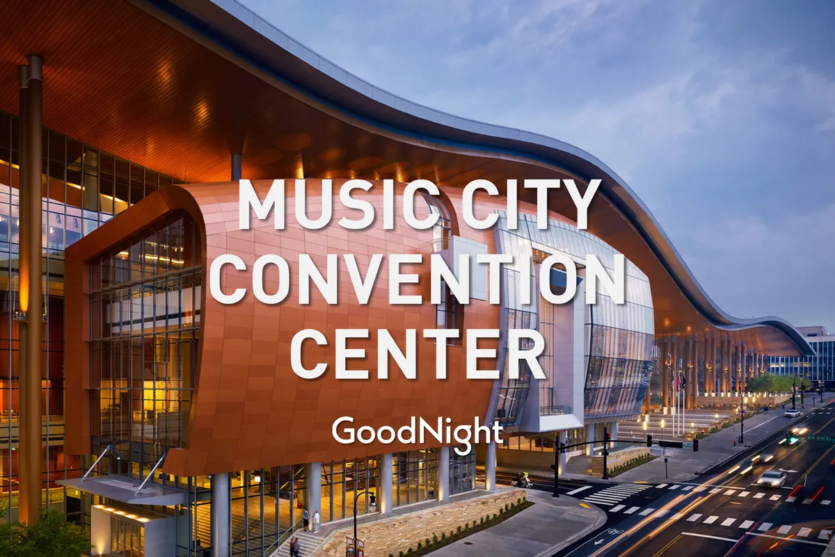 A dynamic exterior view of the Nashville Convention Center, showing its unique architectural design, glowing facade lighting, and a bustling street scene in front. The image captures people arriving and socializing, highlighting the center’s role as a hub for business events and networking.